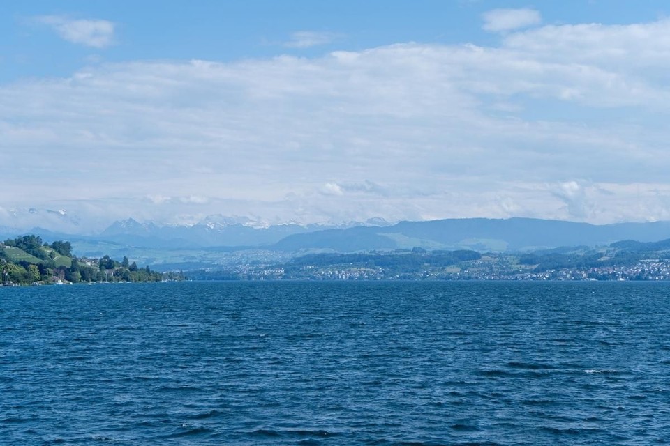 Crystal clear waters of Lake Zurich, with mountains in the background